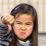little girl with thumbs down when asked what is worst age to start daycare